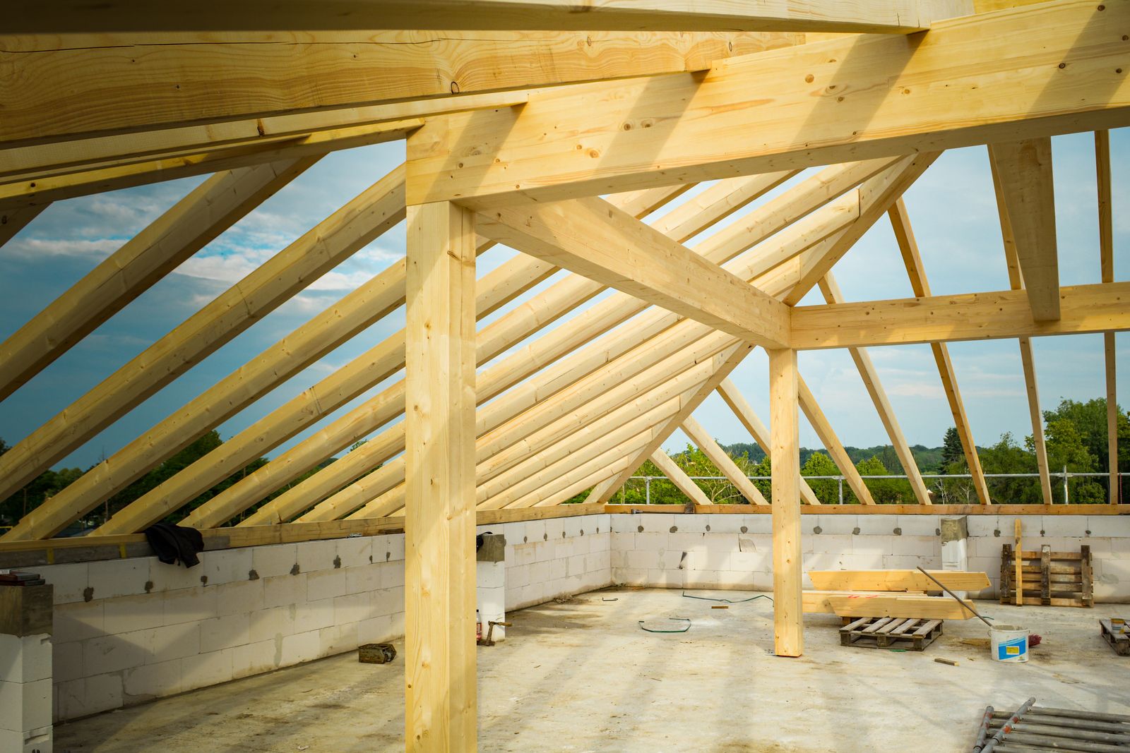 Timber roof trusses framed out against the sky on a building under construction